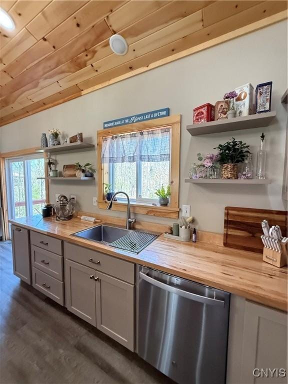26633 Kring Point Rd, Alexandria, NY 13679 - kitchen featuring stainless steel dishwasher, butcher block countertops, open shelves, a sink, and dark wood-style flooring