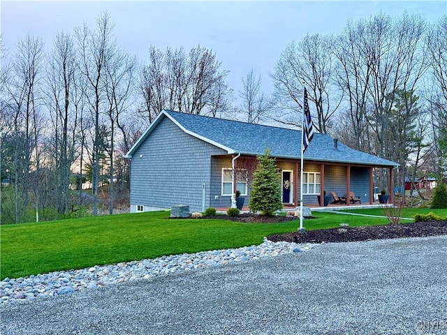26633 Kring Point Rd, Alexandria, NY 13679 - view of front of house with covered porch, a front yard, and roof with shingles