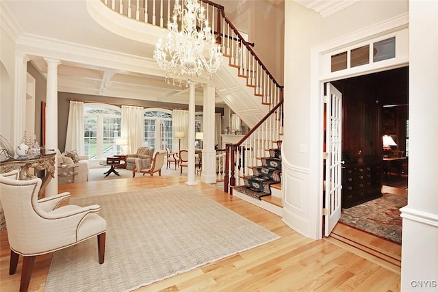 7106 Braxton Cir, Dewitt, NY 13066 - entrance foyer with decorative columns, wood finished floors, stairs, crown molding, and coffered ceiling