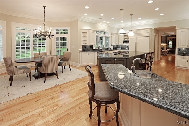 7106 Braxton Cir, Dewitt, NY 13066 - kitchen with a sink, open shelves, a kitchen island, appliances with stainless steel finishes, and a chandelier