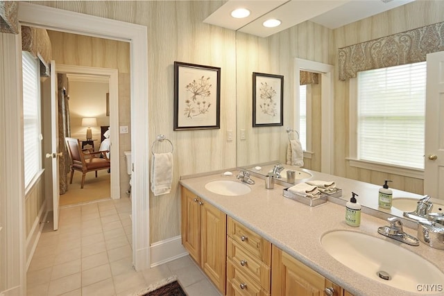 7106 Braxton Cir, Dewitt, NY 13066 - bathroom with wallpapered walls, tile patterned flooring, ensuite bathroom, double vanity, and baseboards