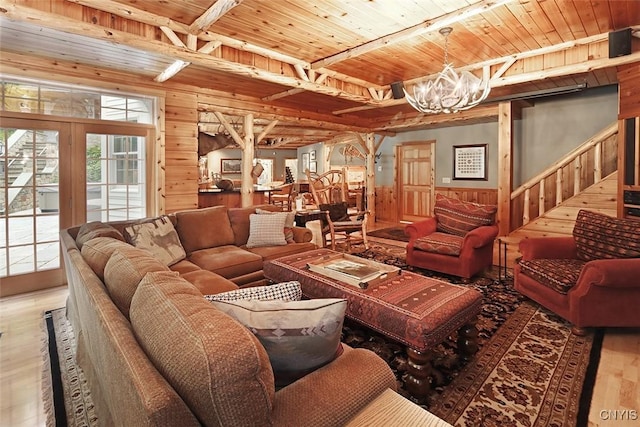 7106 Braxton Cir, Dewitt, NY 13066 - living room featuring wood finished floors, wood walls, a chandelier, wood ceiling, and stairway