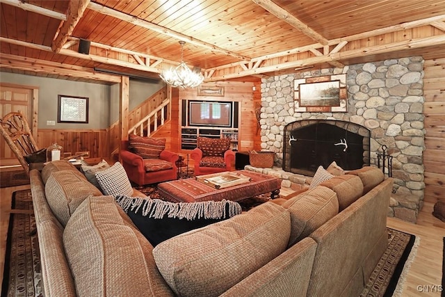 7106 Braxton Cir, Dewitt, NY 13066 - living room with wooden walls, wood finished floors, wood ceiling with exposed beams, a fireplace, and a wainscoted wall