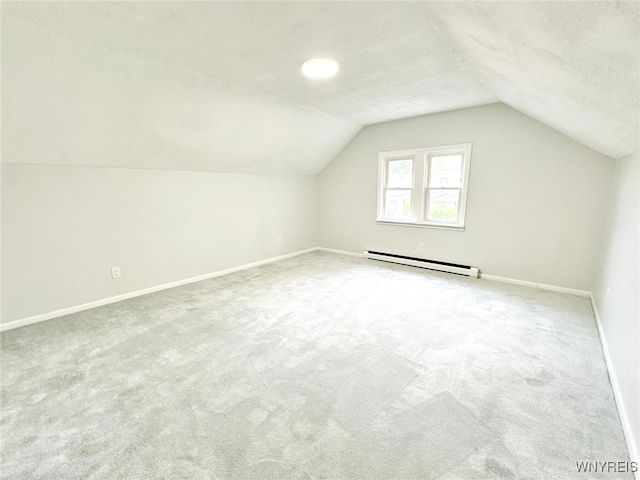 169 Davidson Ave, Buffalo, NY 14215 - additional living space featuring a baseboard heating unit, carpet floors, baseboards, vaulted ceiling, and a textured ceiling