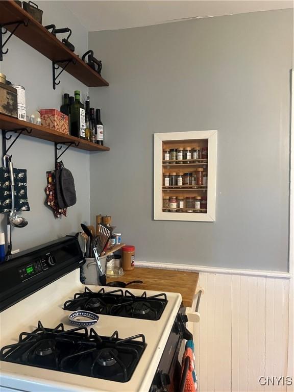 6265 Haslauer Rd, Stockbridge, NY 13409 - kitchen featuring white range with gas cooktop, wainscoting, open shelves, and light countertops