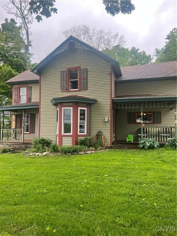 6265 Haslauer Rd, Stockbridge, NY 13409 - rear view of property featuring a porch, a yard, and a shingled roof