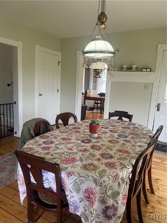 6265 Haslauer Rd, Stockbridge, NY 13409 - dining space with light wood finished floors and a chandelier