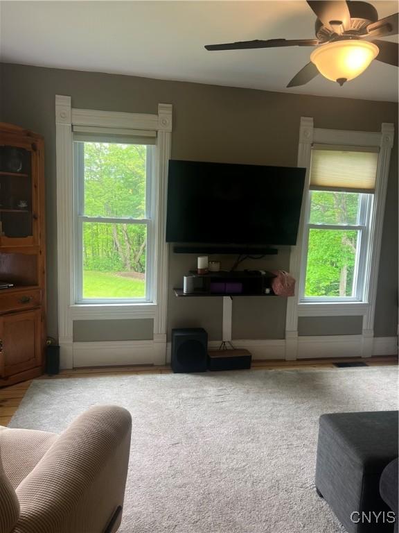 6265 Haslauer Rd, Stockbridge, NY 13409 - living area with healthy amount of natural light and a ceiling fan