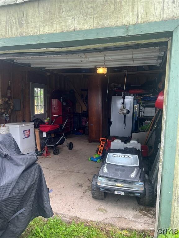 6265 Haslauer Rd, Stockbridge, NY 13409 - garage featuring a garage door opener