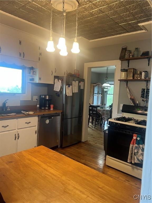6265 Haslauer Rd, Stockbridge, NY 13409 - kitchen featuring stainless steel appliances, an ornate ceiling, open shelves, wood finished floors, and white cabinetry
