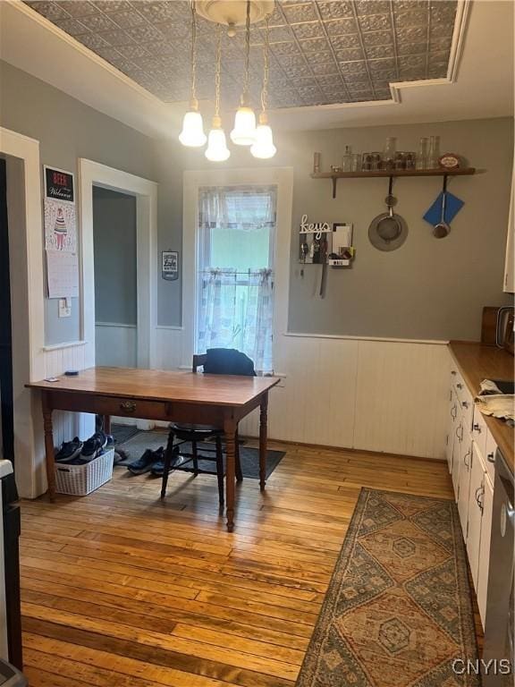 6265 Haslauer Rd, Stockbridge, NY 13409 - dining space featuring an ornate ceiling, light wood finished floors, an office area, a chandelier, and wainscoting