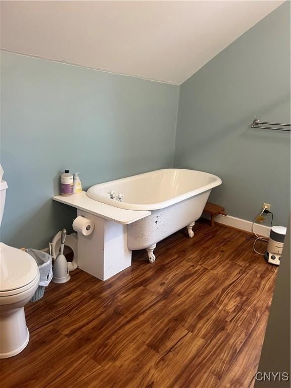 6265 Haslauer Rd, Stockbridge, NY 13409 - full bathroom with a freestanding bath, wood finished floors, toilet, and baseboards