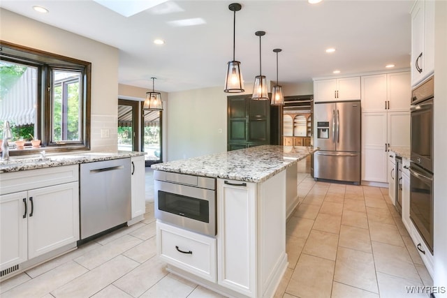 126 Crestwood Ln, Amherst, NY 14221 - kitchen featuring stainless steel appliances, white cabinetry, light tile patterned floors, recessed lighting, and a center island