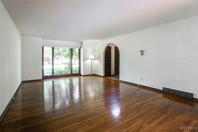 126 Crestwood Ln, Amherst, NY 14221 - empty room featuring arched walkways, wood finished floors, and baseboards
