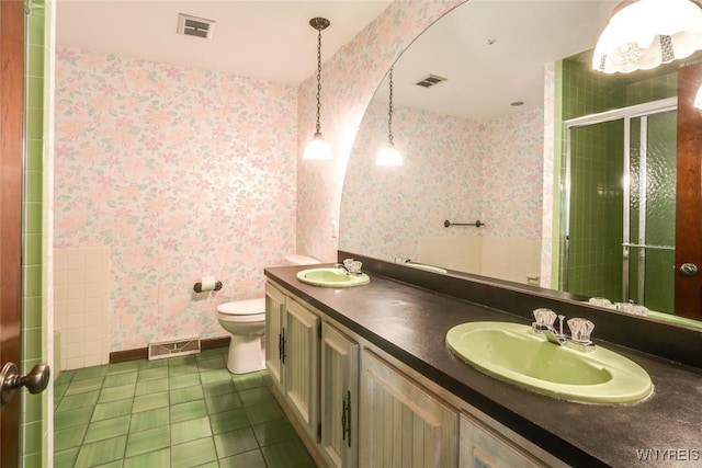 126 Crestwood Ln, Amherst, NY 14221 - full bathroom featuring toilet, double vanity, tile patterned floors, a shower stall, and wallpapered walls