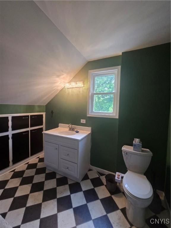 109 State St, Seneca Falls, NY 13148 - bathroom with vaulted ceiling, tile patterned floors, vanity, and toilet