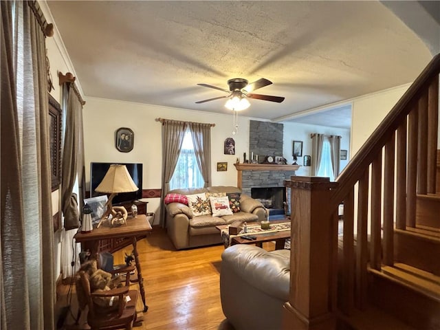 21 Curtis Rd, Hamilton, PA 16333 - living area featuring ceiling fan, a fireplace, crown molding, light wood-type flooring, and stairway