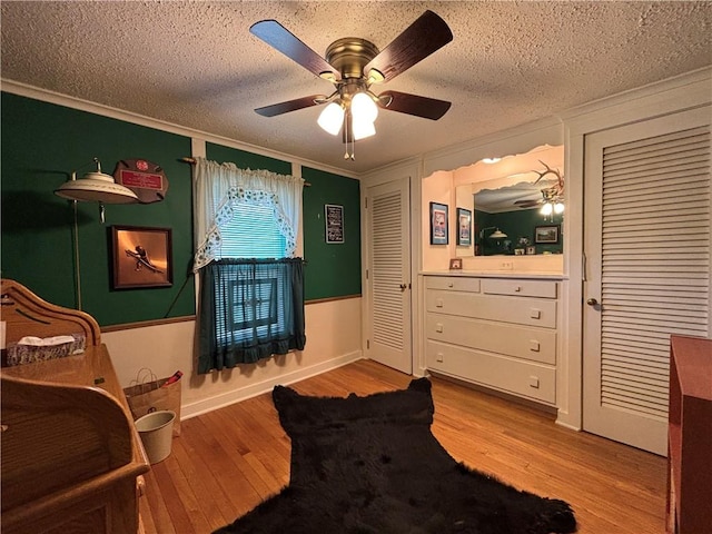 21 Curtis Rd, Hamilton, PA 16333 - bedroom with wood finished floors, ornamental molding, a textured ceiling, ceiling fan, and two closets