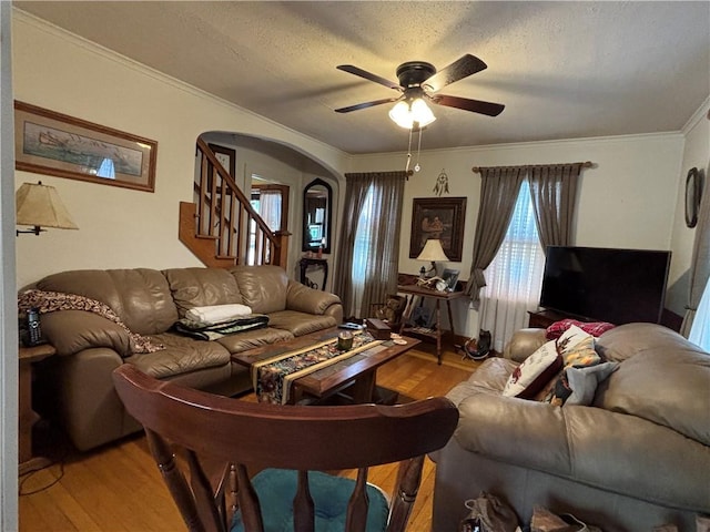 21 Curtis Rd, Hamilton, PA 16333 - living room featuring arched walkways, a ceiling fan, light wood finished floors, stairs, and crown molding