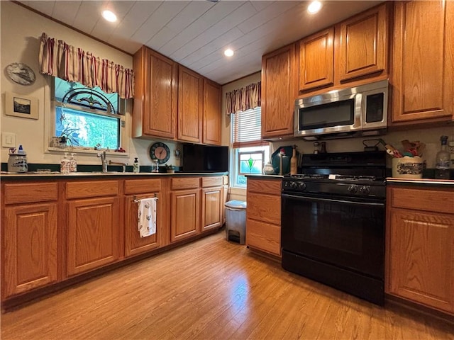 21 Curtis Rd, Hamilton, PA 16333 - kitchen featuring black gas range oven, stainless steel microwave, plenty of natural light, brown cabinets, and recessed lighting