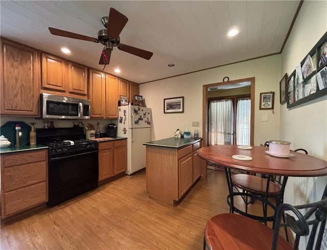 21 Curtis Rd, Hamilton, PA 16333 - kitchen featuring stainless steel microwave, black gas stove, freestanding refrigerator, light wood-style floors, and recessed lighting