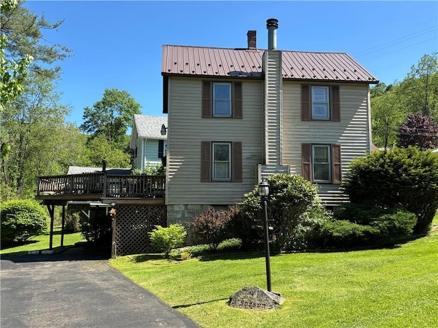 21 Curtis Rd, Hamilton, PA 16333 - view of side of property with a lawn, a wooden deck, and metal roof