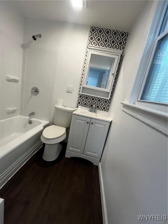 228 Weiss St, Buffalo, NY 14206 - bathroom featuring wood finished floors, toilet, vanity, and bathing tub / shower combination