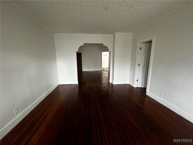 228 Weiss St, Buffalo, NY 14206 - spare room featuring arched walkways, wood-type flooring, and baseboards