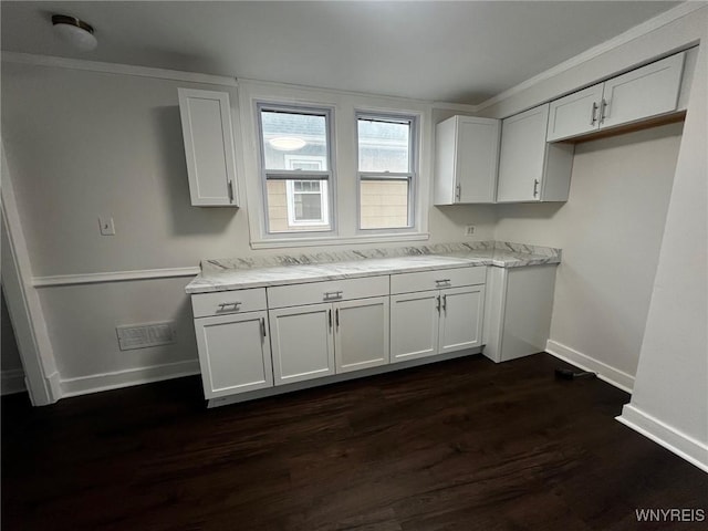 228 Weiss St, Buffalo, NY 14206 - kitchen with baseboards, dark wood-style flooring, white cabinets, crown molding, and light stone countertops