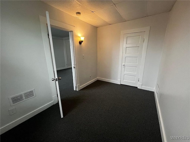228 Weiss St, Buffalo, NY 14206 - spare room featuring a drop ceiling, dark colored carpet, baseboards, and a smoke detector