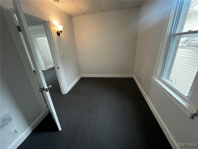 228 Weiss St, Buffalo, NY 14206 - spare room featuring baseboards and dark colored carpet