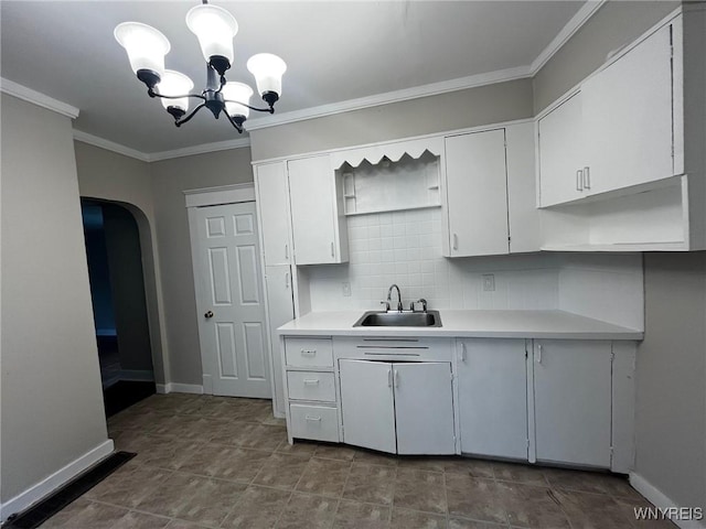 228 Weiss St, Buffalo, NY 14206 - kitchen featuring a sink, a chandelier, arched walkways, light countertops, and baseboards