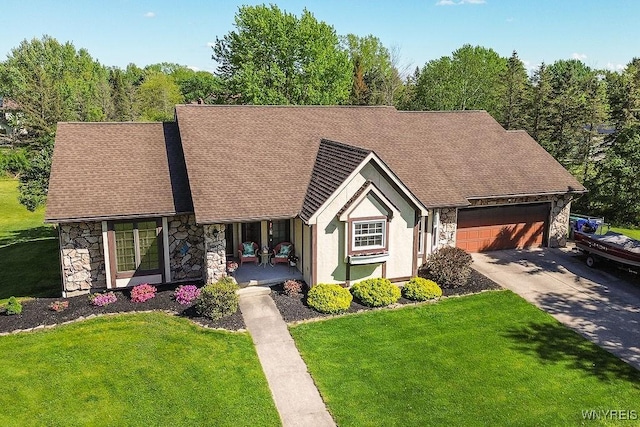 4590 Beach Ridge Rd, Pendleton, NY 14094 - view of front of house featuring stone siding, an attached garage, a front lawn, concrete driveway, and a shingled roof