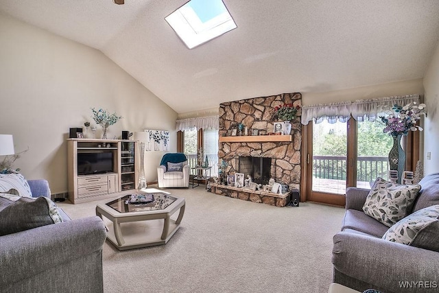 4590 Beach Ridge Rd, Pendleton, NY 14094 - living area featuring healthy amount of natural light, vaulted ceiling, a skylight, carpet floors, and a stone fireplace