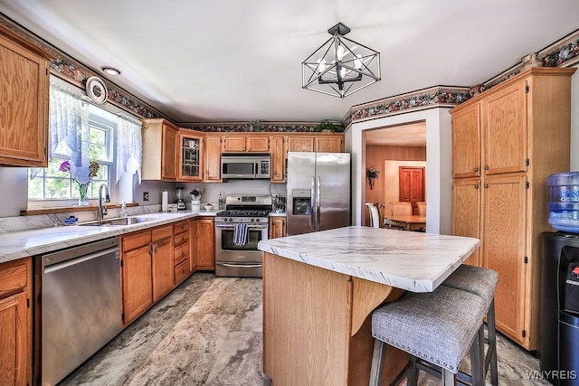 4590 Beach Ridge Rd, Pendleton, NY 14094 - kitchen featuring appliances with stainless steel finishes, a sink, light countertops, and a center island