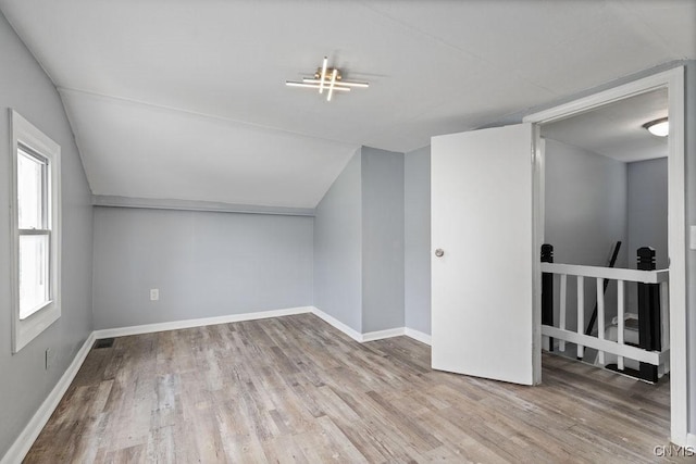 210 Essex St, Syracuse, NY 13204 - additional living space with wood finished floors, lofted ceiling, and baseboards