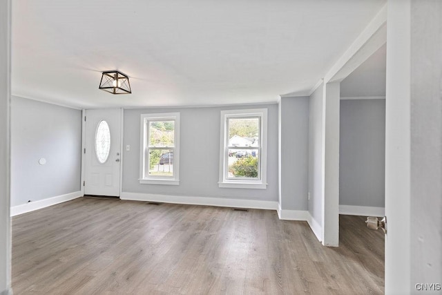 210 Essex St, Syracuse, NY 13204 - foyer entrance with baseboards, wood finished floors, and ornamental molding