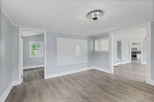 210 Essex St, Syracuse, NY 13204 - unfurnished dining area featuring crown molding, wood finished floors, baseboards, and ceiling fan