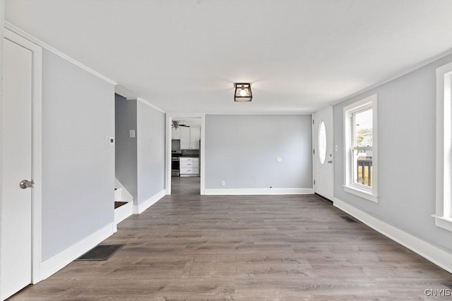 210 Essex St, Syracuse, NY 13204 - empty room with wood finished floors, baseboards, ornamental molding, and ceiling fan
