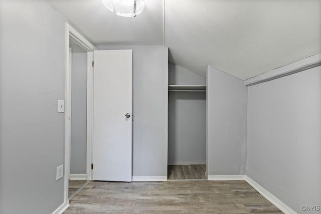 210 Essex St, Syracuse, NY 13204 - unfurnished bedroom featuring vaulted ceiling and wood finished floors
