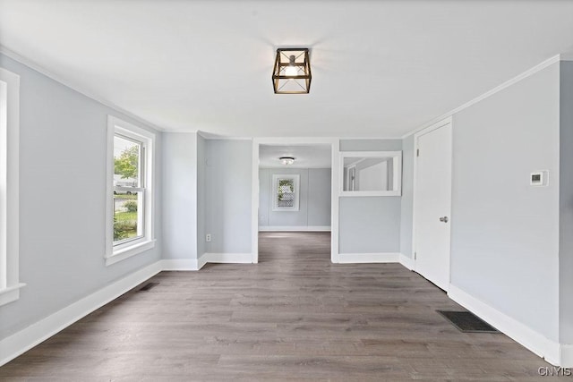 210 Essex St, Syracuse, NY 13204 - spare room with wood finished floors, crown molding, and baseboards