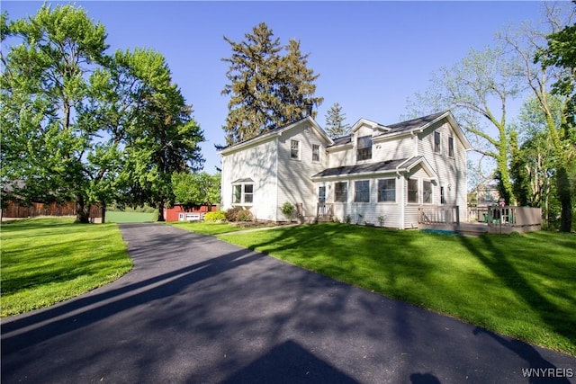 4748 Thrall Rd, Cambria, NY 14094 - traditional-style home featuring a front lawn and a deck