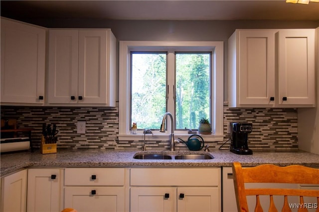 4748 Thrall Rd, Cambria, NY 14094 - kitchen with a sink, white cabinets, tasteful backsplash, and light stone countertops