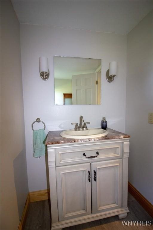 4748 Thrall Rd, Cambria, NY 14094 - bathroom featuring vanity, baseboards, and wood finished floors