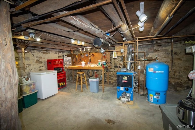 4748 Thrall Rd, Cambria, NY 14094 - unfinished basement with a workshop area, fridge, a water pressure tank, and a heating unit