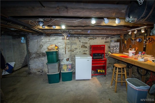 4748 Thrall Rd, Cambria, NY 14094 - unfinished below grade area featuring a workshop area and fridge