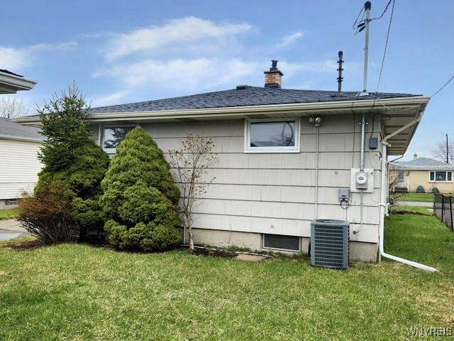 146 Lou Ann Dr, Cheektowaga, NY 14043 - view of home's exterior with a chimney and roof with shingles