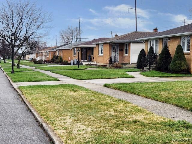 146 Lou Ann Dr, Cheektowaga, NY 14043 - ranch-style house with a front yard, a chimney, and a residential view