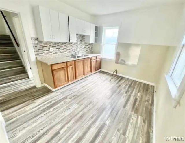 199 Berkshire Ave, Buffalo, NY 14215 - kitchen with light wood-type flooring, tasteful backsplash, light countertops, baseboards, and brown cabinets