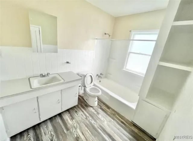 199 Berkshire Ave, Buffalo, NY 14215 - full bath featuring vanity, washtub / shower combination, toilet, wood finished floors, and wainscoting